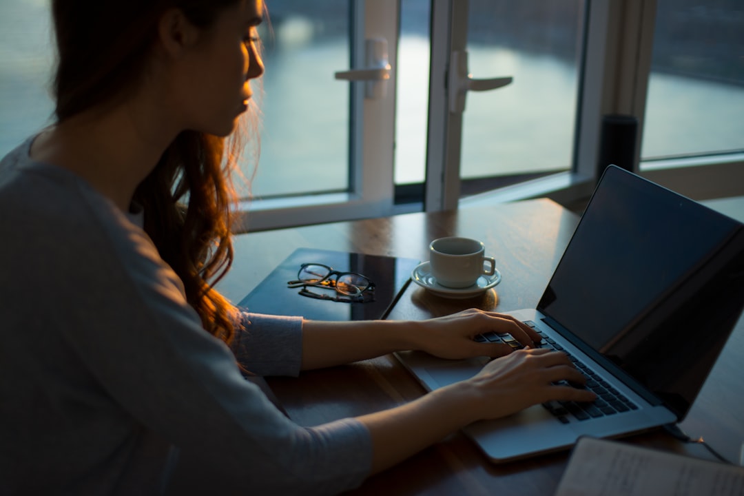 Marketer working on a laptop in warm natural light